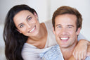 Image of a happy couple smiling with dentures