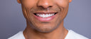 close up of a man smiling with dentures